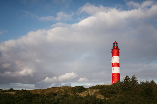 Lighthouse tower against cloudy sky
