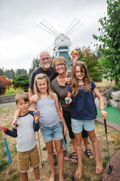 Grandparents and grandkids pose for picture while playing minigo