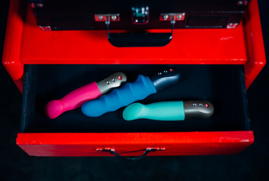 Drawer Of Pink Blue and Green Dildos and Sex Toys