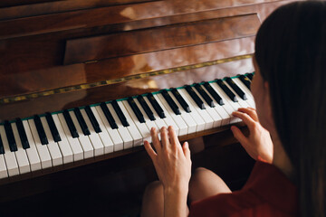 Close up of woman playing piano