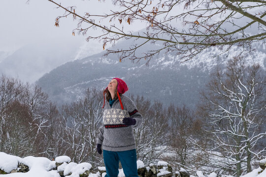 woman looking at falling  snow