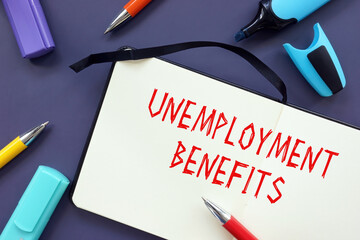  Unemployment Benefits phrase on the piece of paper.