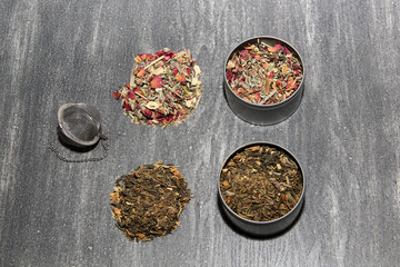 Tools for preparing herbal infusions: glass cup, infuser, spoon, dried dehydrated herb to relax or cure diseases
