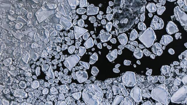 overhead view of a frozen river with ice flows