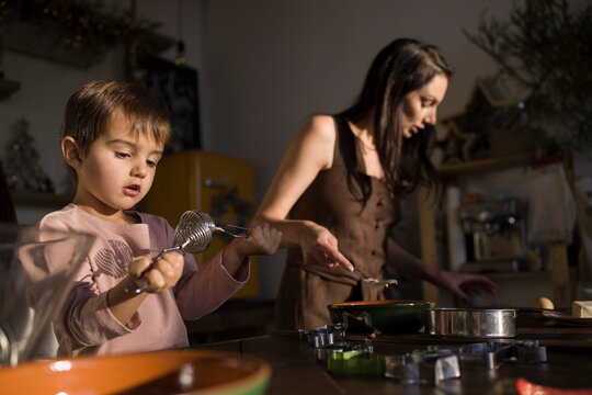 Mother and little sin baking together 