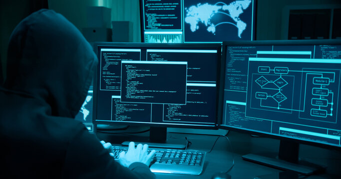Asian male hacker use laptop
