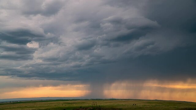 Timelapse of rain falling from storm cell over the plains in South Dakota rolling over the flat horizon.