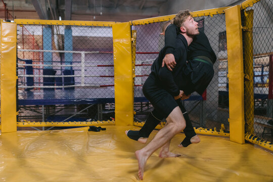 Wrestler fighting bout at gym 