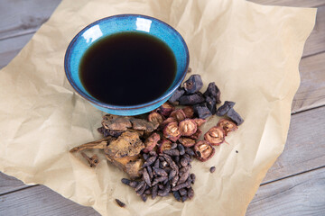 Medicinal herbs and soup on kraft paper

