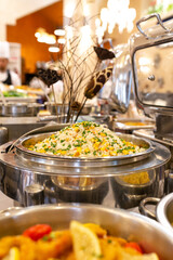 steamed rice with corn and green onions in a saucepan