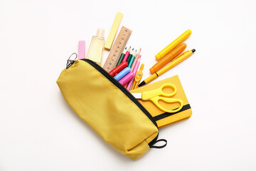 Pencil case with stationery on white background