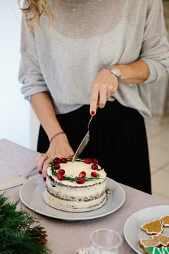 A woman cutting a cake