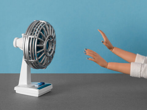Color blocking still life with a doll in front of a fan