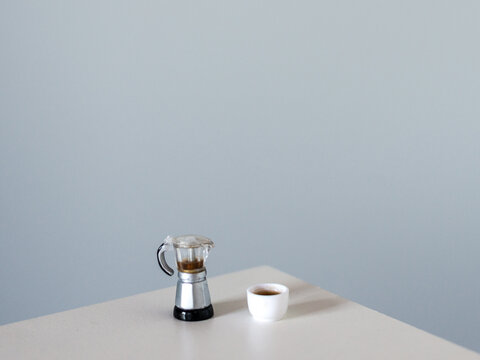 Coffee pot and coffee cup on a white table