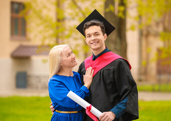 Happy young man with his mother on graduation day