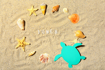 Date of World Ocean Day with sea shells on beach sand