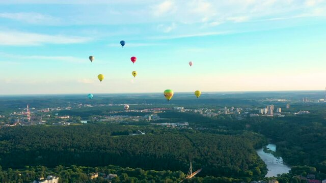 Colorful Hot Air Balloons Flying Over The City Of Vilnius, Lithuania During Summertime. - Aerial Shot
