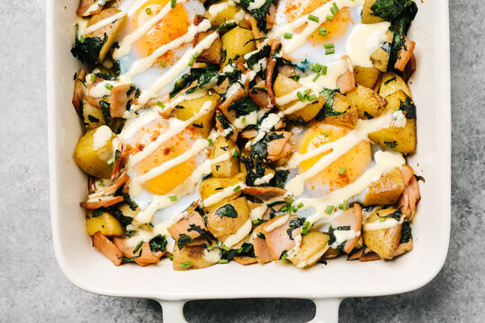 Eggs Benedict Casserole with drizzled Hollandaise sauce