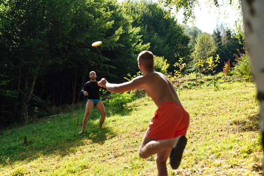 Men Catching A Frisbee 
