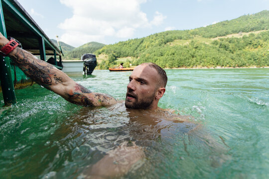 Man Enjoys The Lake Water 