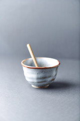 Traditional, handcrafted ceramic on gray background. Soft focus. Close up. Copy space.