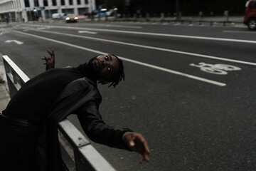 Young Afro Man SUrfing the Traffic on the Street
