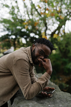 Handsome man Using a Mobile Phone in the City Park