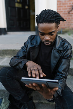 Afrom Man using Digital Tablet Outdoors