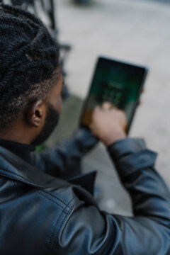 Afrom Man using Digital Tablet Outdoors