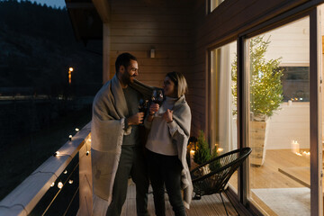 Couple hangout on a terrace at Christmas evening