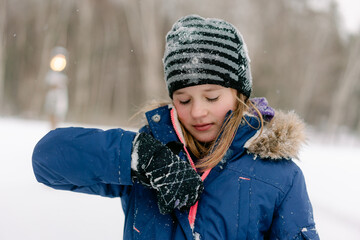 young girl closing her jacket 
