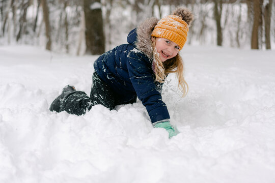 young girl playing in the snow 