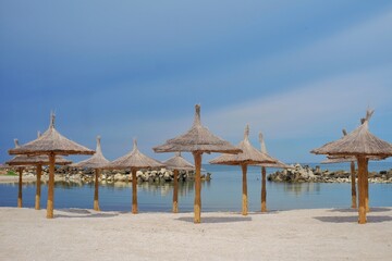 Beach with umbrellas on the shores of the Black Sea.  The ideal place to relax and spend wonderful moments.
