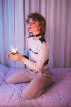 Model boy with candle and colour reflections