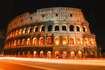 Fototapeta na wymiar night view of Colosseum, with trails of passing vehicle. Rome