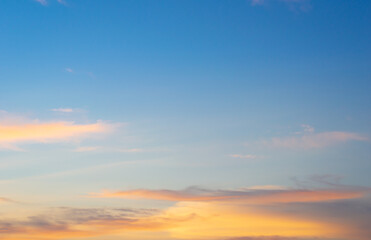 Beautiful sky painted by the sun leaving bright golden shades.Dense clouds in twilight sky in winter evening.Image of cloud sky on evening time.Evening sky scene with golden light from the setting sun