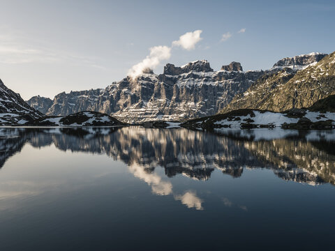 Alpine lake with mountain reflection.