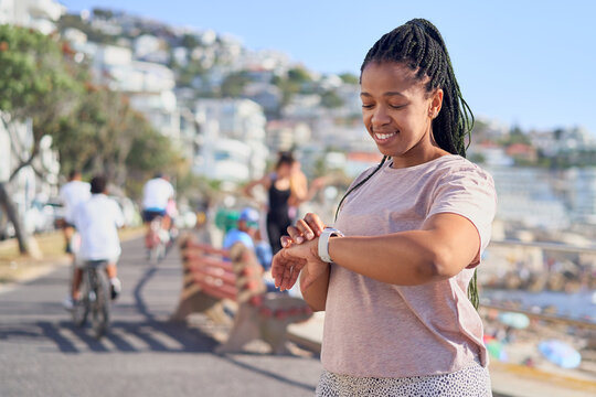 smiling fitness woman using activity tracker