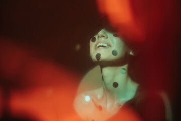 Happy woman with metallic circles on face
