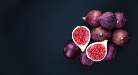 Fresh ripe figs on dark Background. Violet figs with copyspace close up. Creative Food photo.
