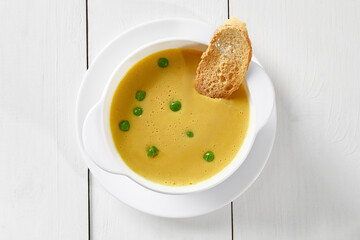 Pea cream soup in turkey broth with toast