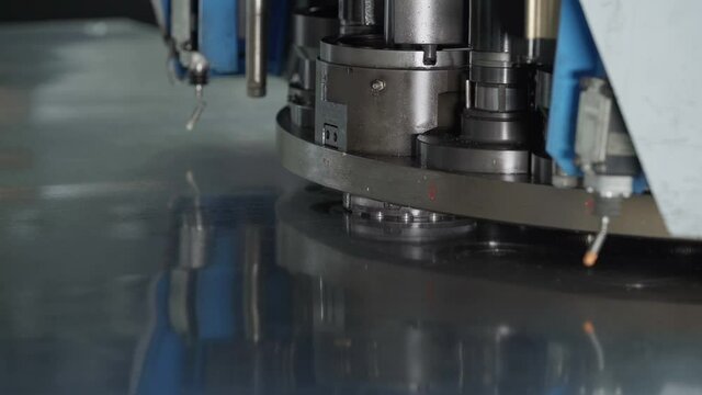 Equipment Manufacturing Facility. Advanced Stamping Machine Working Automatically. Moving a Sheet of Metal and Creating Bending Marks on its Surface. Industrial Machinery. Modern CNC Industrial line