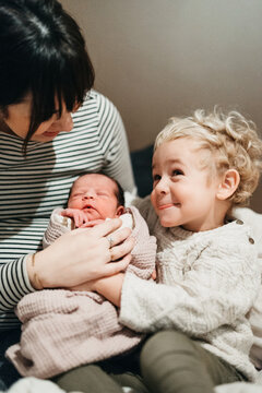 brother meeting new born sister for the first time
