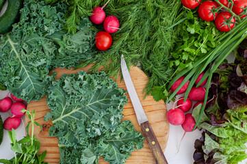 Home cooking. The process of cooking healthy, vegan food. Women's hands cut grass on a wooden...