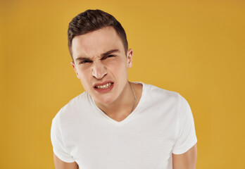Obraz premium handsome man in white t-shirt looking aside emotions isolated background