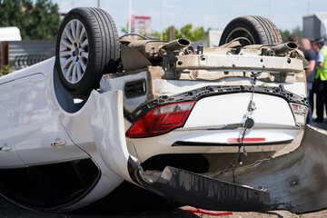 Car accident on the road. A fragment of a car overturned on the roof after a collision with an...