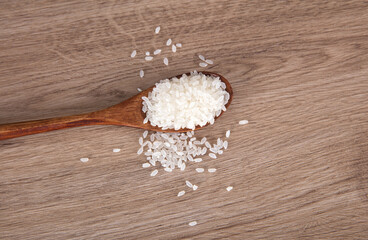 Fototapeta na wymiar A spoonful of rice grain on the table