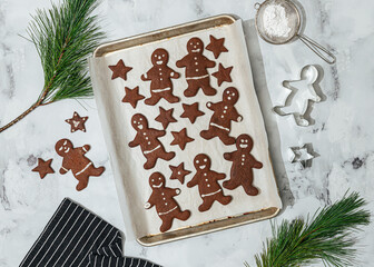 Decorated gingerbread cookies on a baking tray

