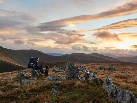 Walker and his dogs on route to High Street and High Raise at sunset.