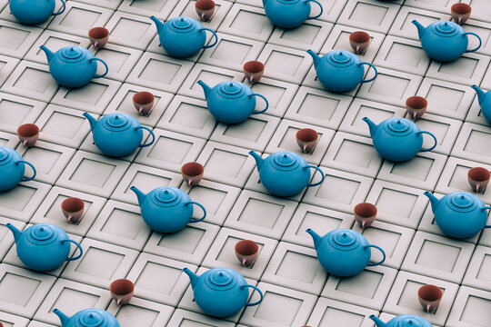 Blue teapot with teacups on grey background